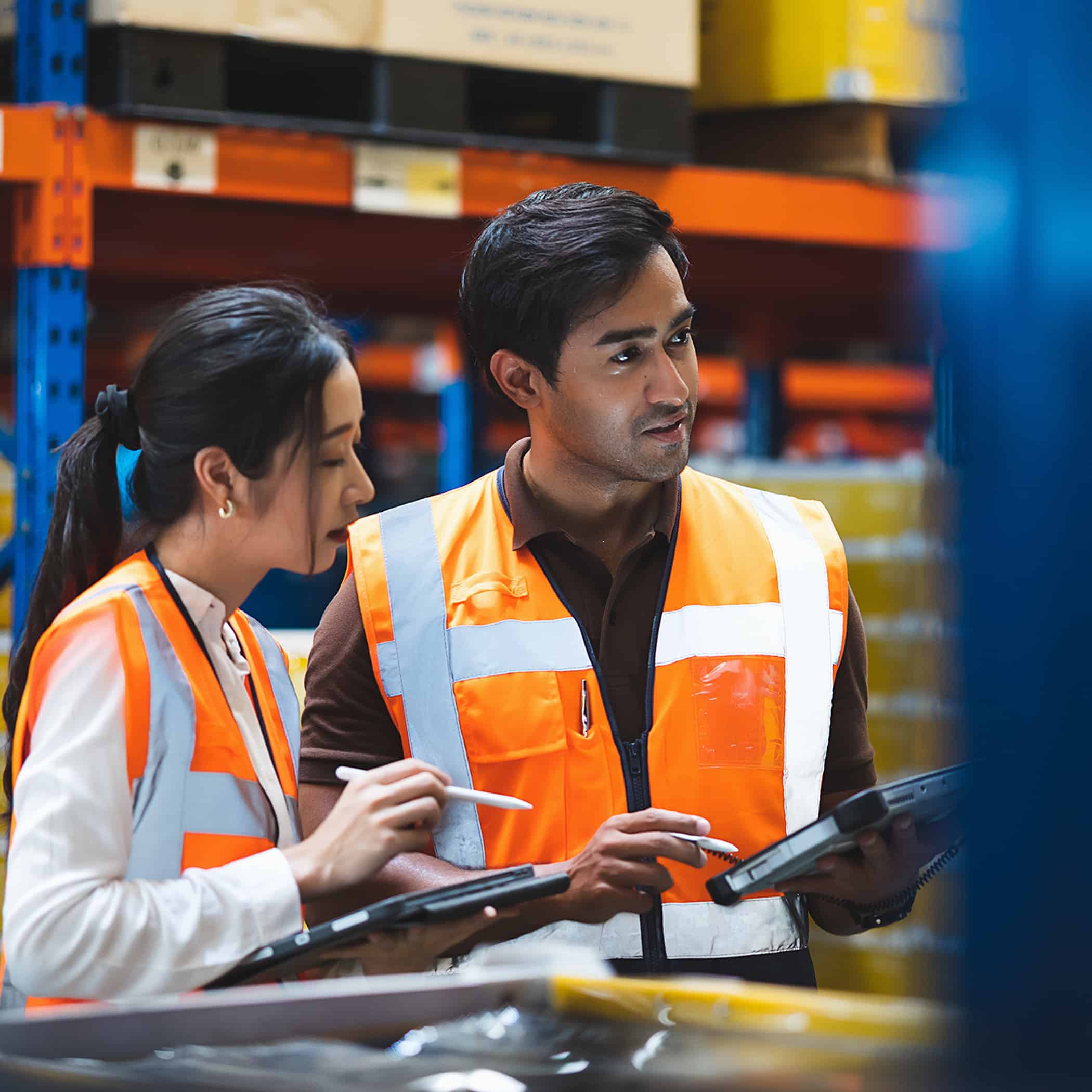 Warehouse worker and manager checks stock and inventory